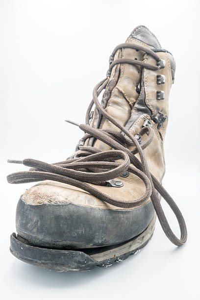 Black leather hiking boots on a black rubber mat