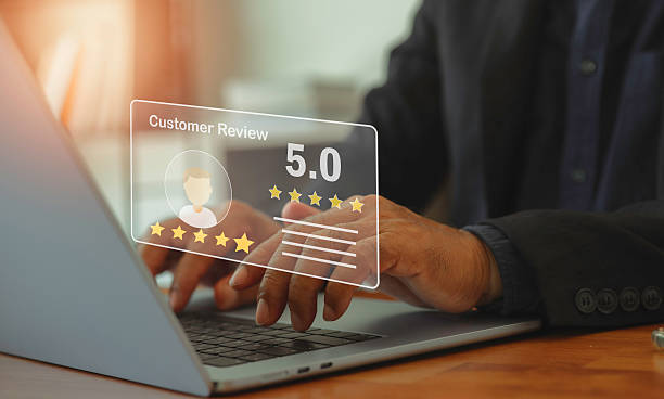 istock man using laptop to give 5 star ratingfeedback of quality experience on online application, customer reviews evaluate the quality of product suggestion satisfaction and good quality. 2213362218