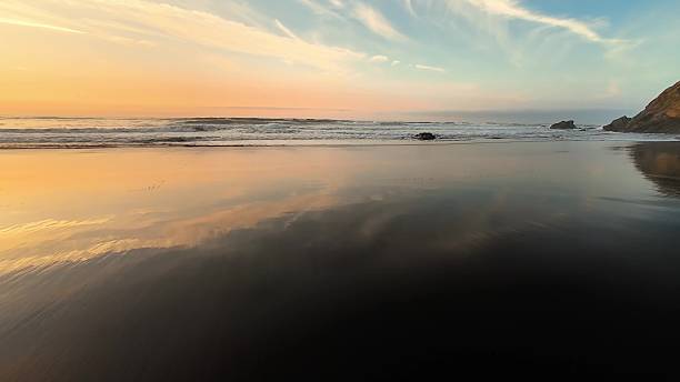 istock The Serene Beach Sunset Creates a Beautiful Reflection on the Tranquil, Calm Waters 2213362443