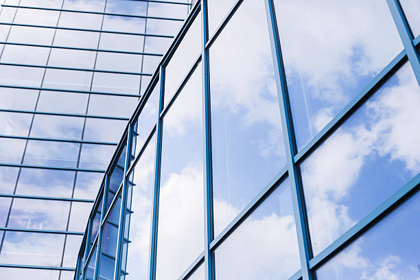istock Modern glass building. Blue glass facade. Cloud reflections corporate architecture. 2213364109