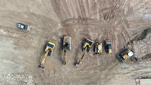 istock heavy construction machinery on a construction site from a drone 2213364740