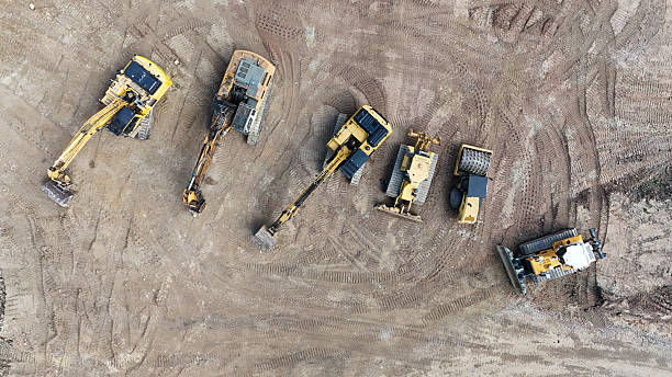 istock heavy construction machinery on a construction site from a drone 2213364786