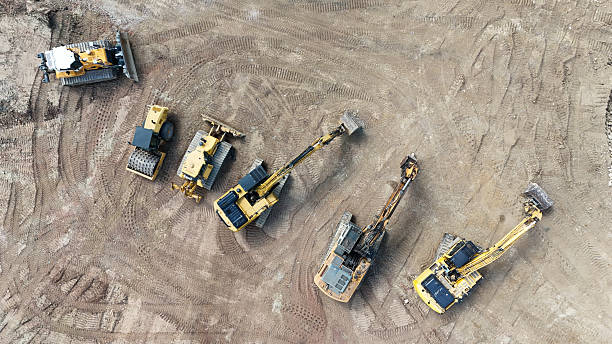 istock heavy construction machinery on a construction site from a drone 2213364788