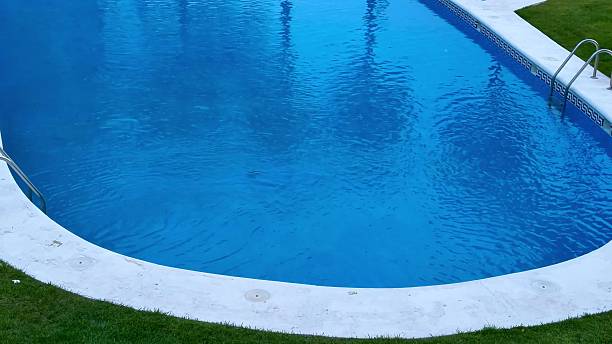 istock A tranquil swimming pool surrounded by lush greenery with a stunning urban view 2213368917