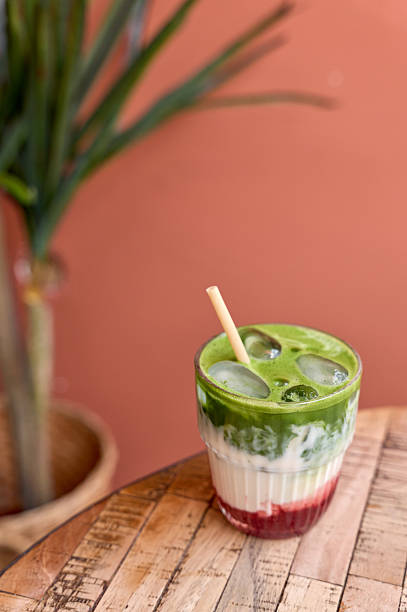 istock Iced matcha latte with raspberry syrup on a wooden table 2213370044