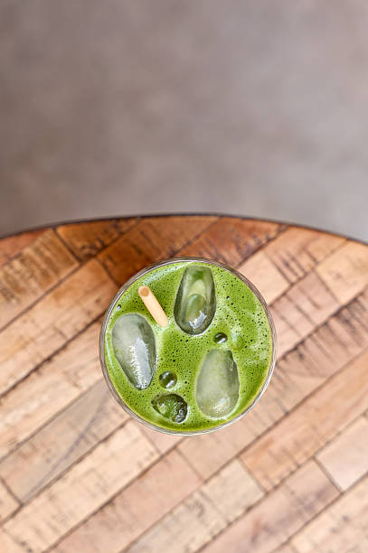 Iced matcha latte resting on wooden table