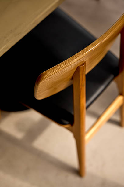 istock Modern wooden chair tucked under table in minimalist setting 2213370201