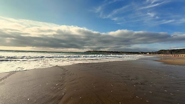 istock A stunning beach landscape showcasing beautiful waves crashing under the dramatic clouds 2213375070