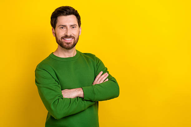 istock Portrait of attractive guy experienced worker hold folded arms demonstrating empty space ad adv isolated yellow color background 2213377584