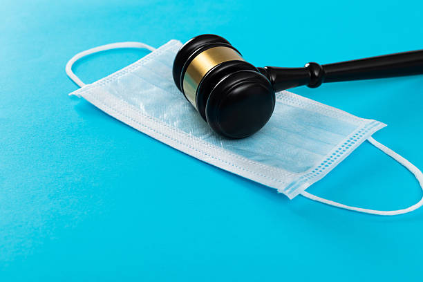 istock Gavel and protective face mask on blue background 2213378263