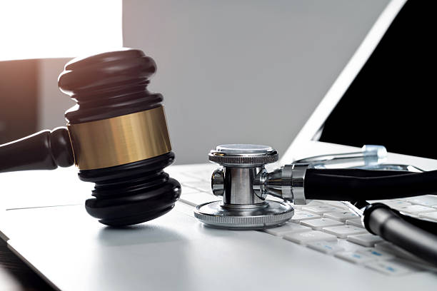 istock Gavel and stethoscope on laptop keyboard 2213378323
