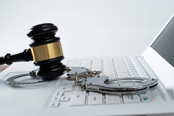 istock Gavel and handcuffs on laptop keyboard 2213378327