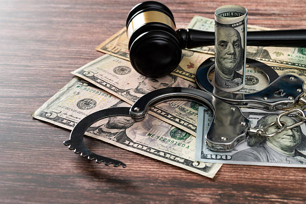 istock Gavel and handcuffs on stack of US paper currency 2213378345