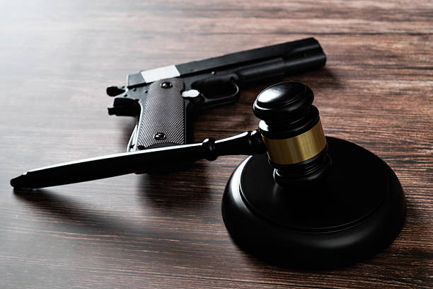istock Gun and gavel on the table 2213378348