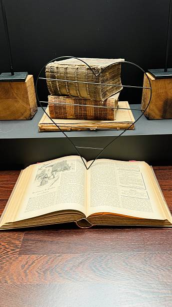 istock In a library, Working with a book from 1892 2213378553