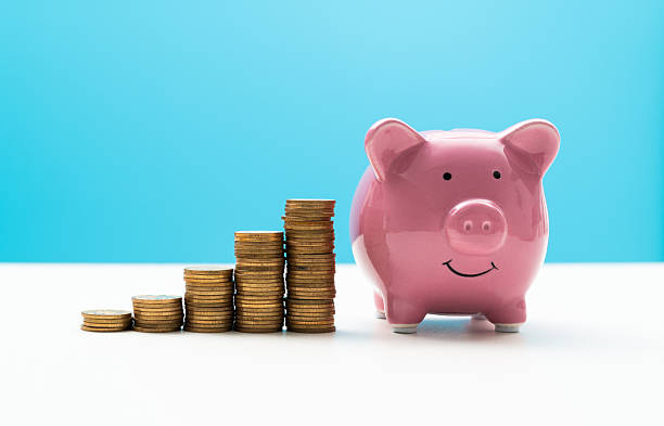 istock Piggy bank and coin steps on the table 2213378742