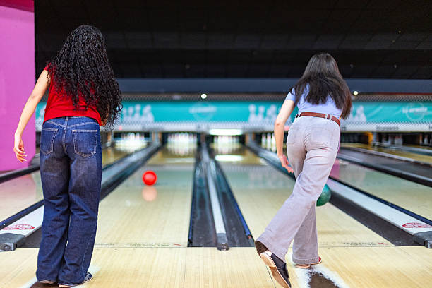 istock Women playing bowling in a bowling alley 2213379962