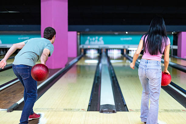 istock Friends playing bowling, throwing balls, having fun and enjoying their weekend together 2213379978