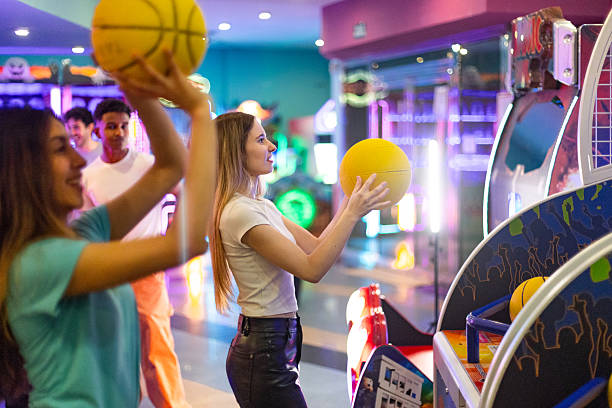 istock Friends playing arcade basketball game, having fun together 2213379998