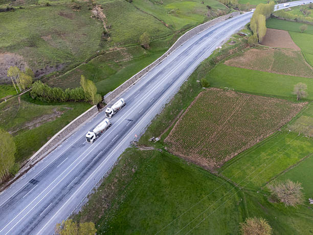 istock A truck transporting freight through green pastures. 2213380116