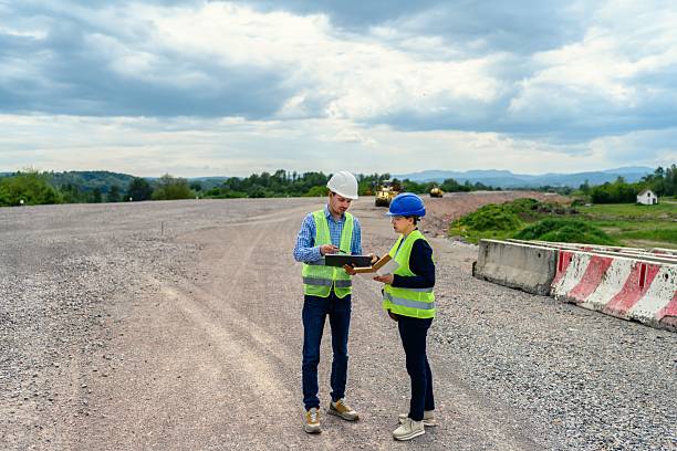 istock Engineer and investor on a road construction site 2213380173