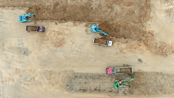 istock Aerial View of Excavators Loading Dump Trucks at Construction Site 2213383666