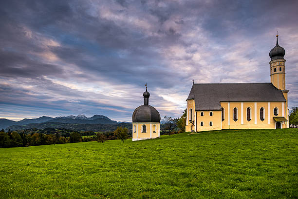 Rain clouds over the Wilparting pilgrimage church in the municipality of Irschenberg (Bavaria).