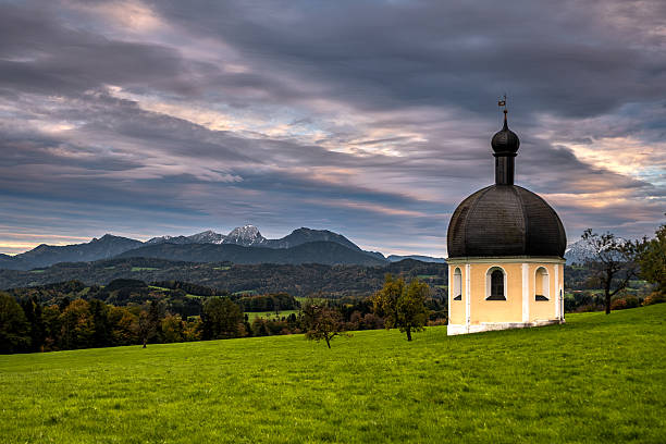 Rain clouds over the Wilparting pilgrimage church in the municipality of Irschenberg (Bavaria).