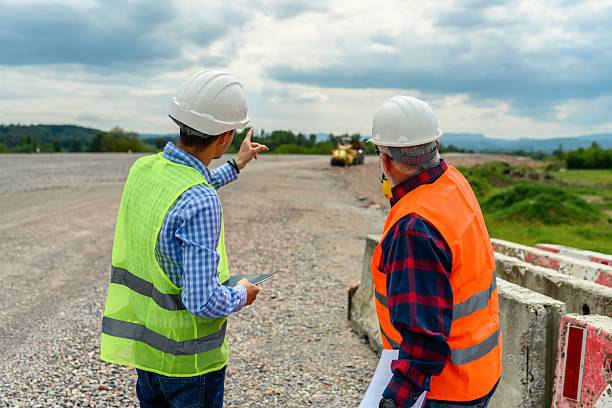 istock Engineer and investor on a road construction site 2213390741