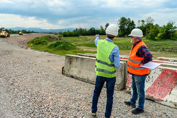 istock Engineer and investor on a road construction site 2213391719