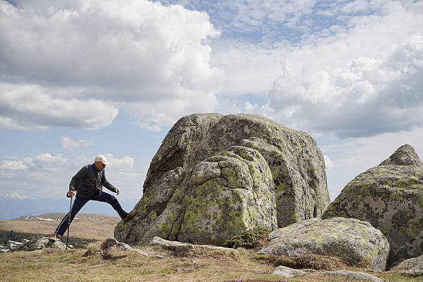 A man hikes on the mountain in a sunny day.