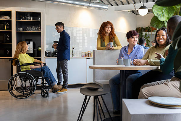 istock Diverse business team enjoying coffee break in modern coworking space 2213399521