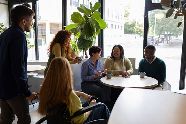 istock Diverse business team enjoying coffee break in modern coworking space 2213399635