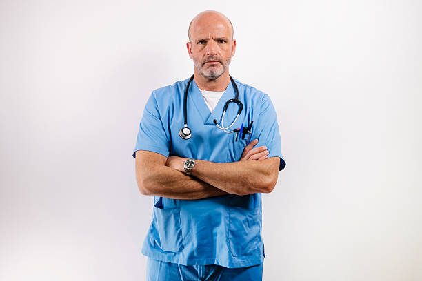 istock A Doctor in light blue gown looking at camera in studio. 2213403045