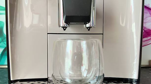 istock A stateoftheart Modern Coffee Machine that comes with a sleek Glass Mug for stylish enjoyment 2213403519
