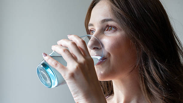 istock young woman drinking water 2213403531