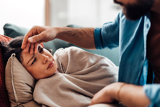 istock Caring man checking temperature of sick partner at home 2213403576