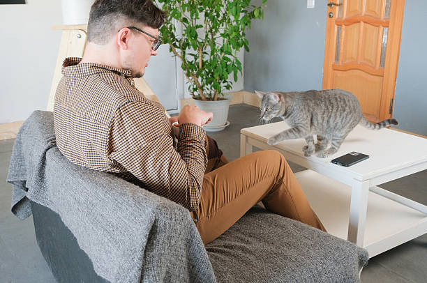 istock Caucasian man playing video games and petting cat 2213406966
