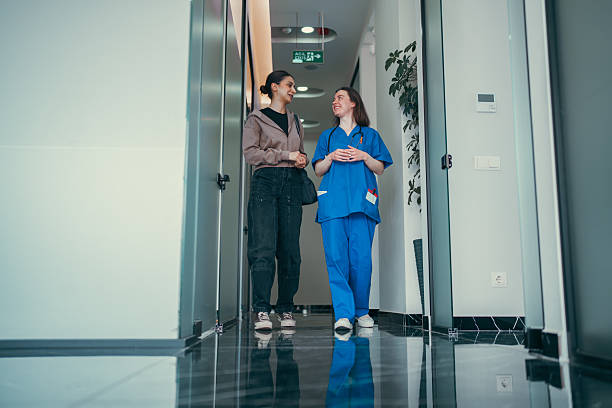 istock Healthcare Worker Walking with Patient in Corridor 2213407154