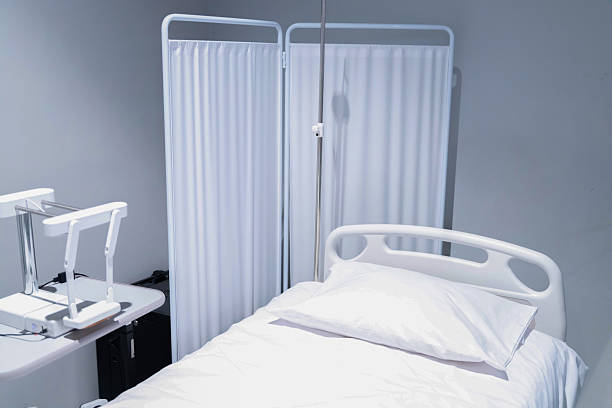 istock Empty hospital bed with emergency equipment. 2213411149