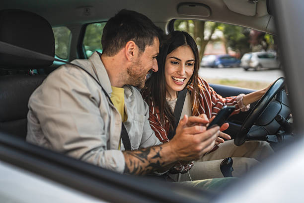istock couple use mobile phone to find route while riding in the car 2213411203