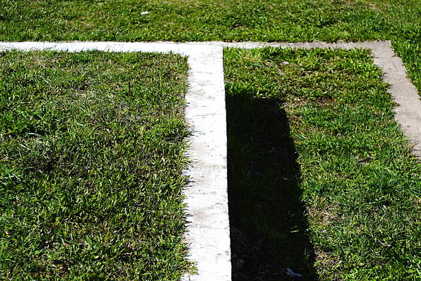 Close-up view of a baseball base on a well-maintained green field, emphasizing sports and teamwork.