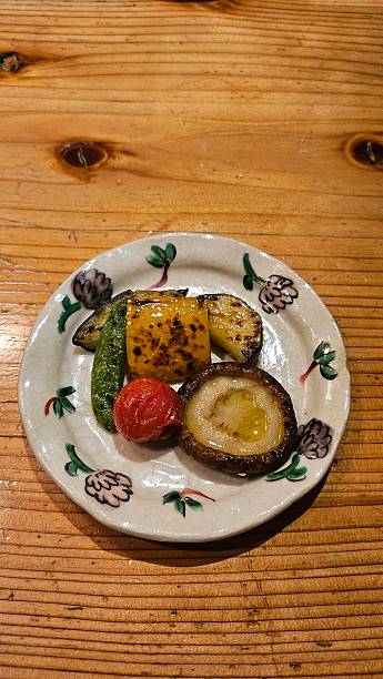 Plated grilled vegetable in japanese style - mushroom, cherry tomato, corn, etc