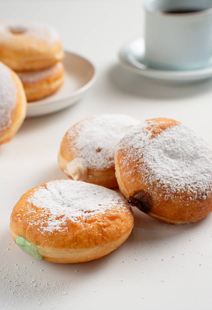 istock Powdered jelly-filled donuts with creamy fillings on white background 2213418372