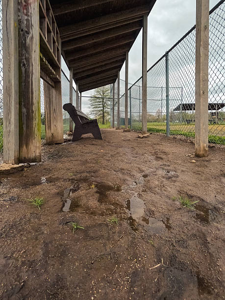 istock Wet and Muddy Dugout in a Baseball Field 2213419076
