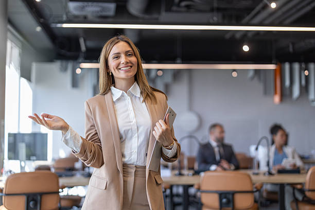 istock Joyful Woman Presenting Ideas in a Modern Office Setting 2213421291