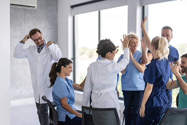 istock Dynamic Gathering of Nurses in Playful Celebration 2213421514