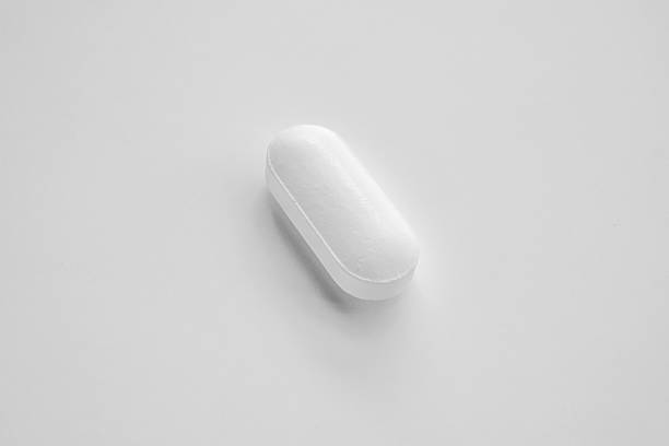 istock White medicine pill tablet on white background 2213421766