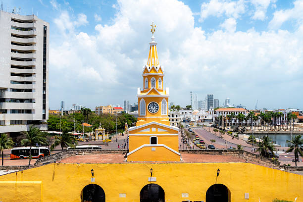 istock Cartagena Clock Tower Behind Yellow Wall at Noon 2213425741