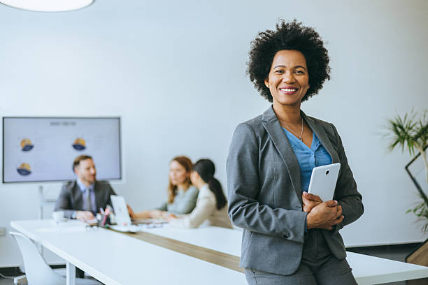 istock Confident businesswoman with tablet in office 2213428772